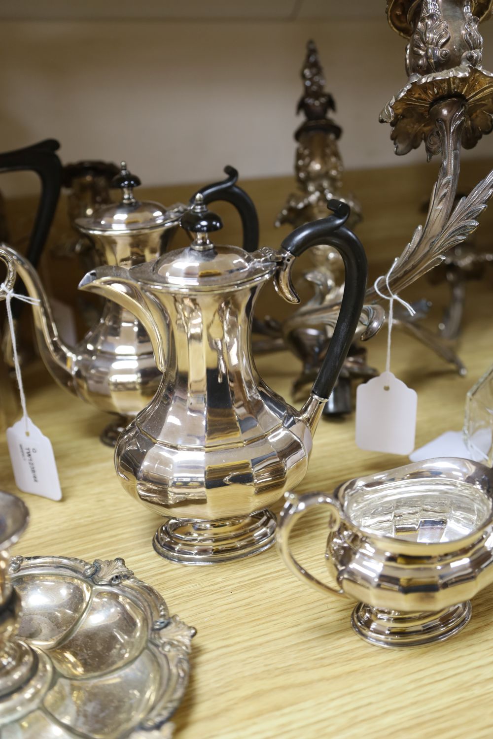 An ornate three-branch plated candelabrum with tulip sconces and sundry plated items,